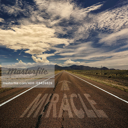 Conceptual image of desert road with the word miracle and arrow