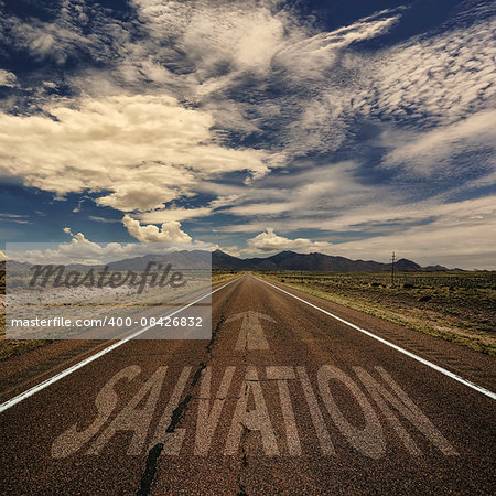 Conceptual image of desert road with the word salvation and arrow