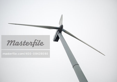 Windmill on a cloudy day. Windmill for electric power production. Renewable electric energy.