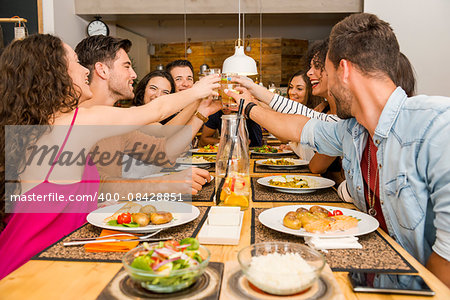 Group of friends toasting and looking happy at a restaurant