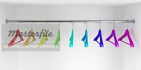 Rainbow colored hangers in the closet