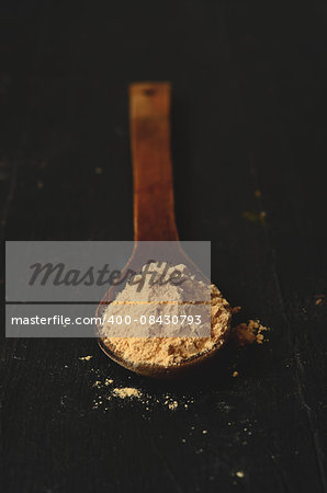 maca root powder in a wooden spoon