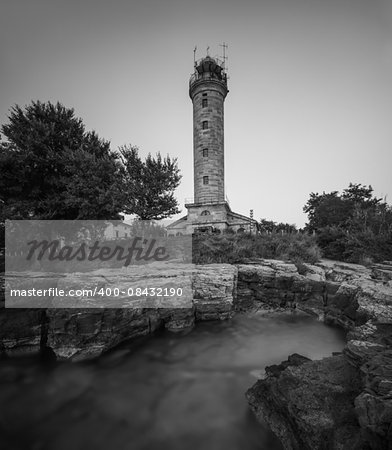 Savudrija Lighthouse on Rocky Coast, the Most Western Point of the Balkans Peninsula and the Oldest Lighthouse in Croatia (Built 1818). Black and White.