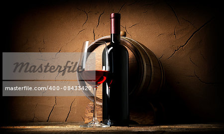 Old red wine in cellar near clay wall