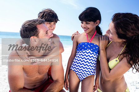 Cute family having a funny discussion on the beach