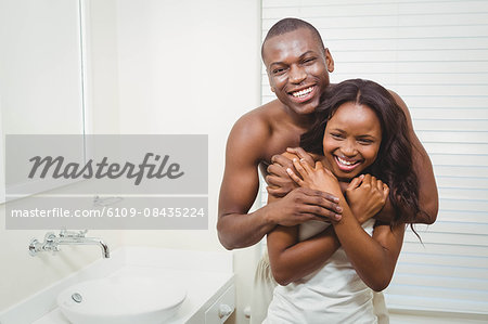 Cute couple cuddling in pajamas in the bathroom