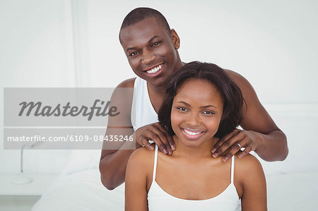 Man massaging his girlfriend in their room