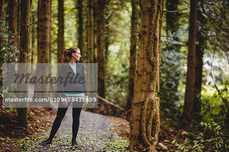 Fit brunette taking a break in the woods
