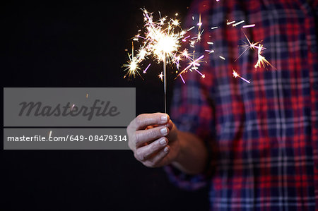 Woman's hand holding sparkler