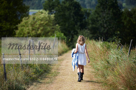 Girl walking on dirt road