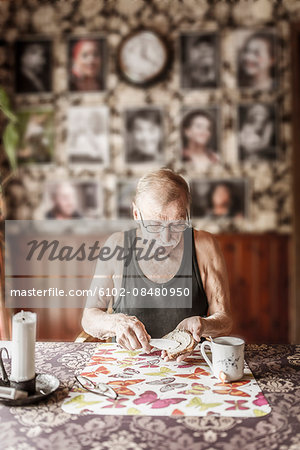 Senior man eating breakfast