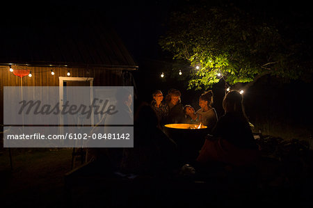 Friends in garden at night