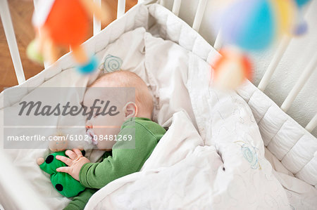 Baby sleeping in cot Baby sleeping in cot
