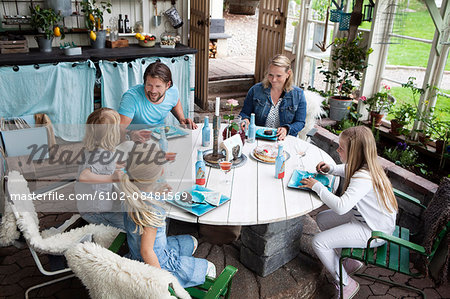 Family with three children eating dessert