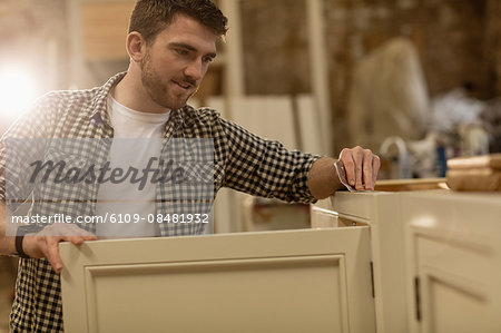 Carpenter working on his craft in a dusty workshop