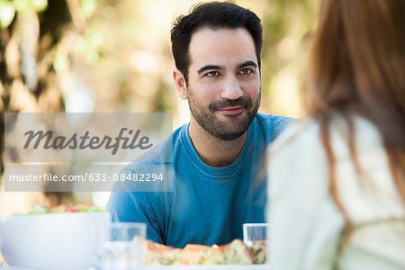 Man having meal outdoors with date