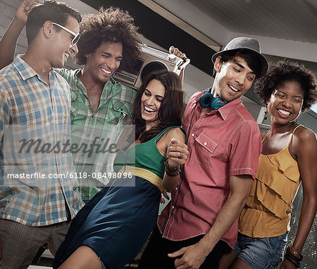 A group of friends, men and women hanging out together, partying.
