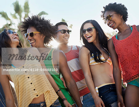 A group of friends, men and women hanging out together, partying.