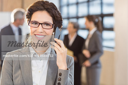 Businesswoman using her smartphone at the office