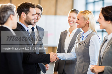 Business team standing and speaking at the office
