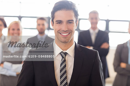 Business team smiling at the camera at the office