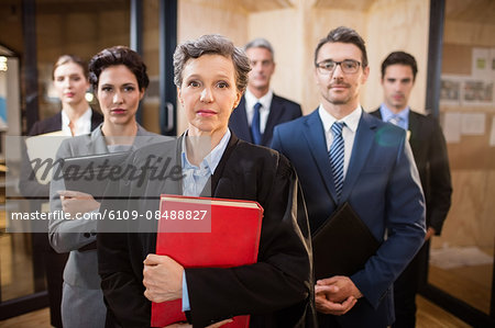 Legal team looking at the camera at the office