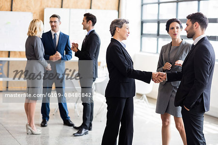 Business people standing and talking at the office