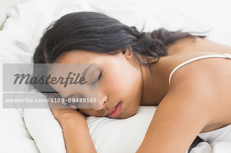 Pretty woman sleeping in bed at home in bedroom