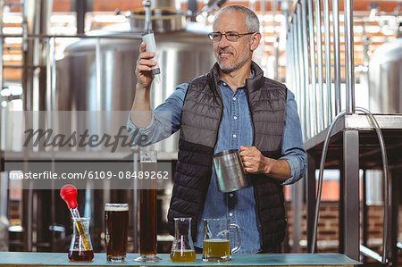 Happy brewer checking his product at the local brewery