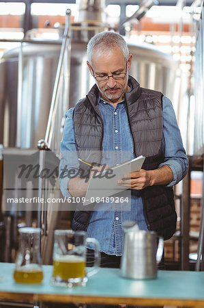 Happy brewer checking his product at the local brewery