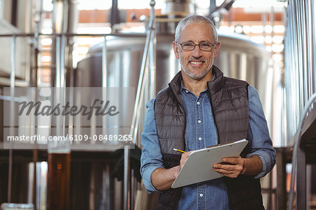 Happy brewer checking his product at the local brewery