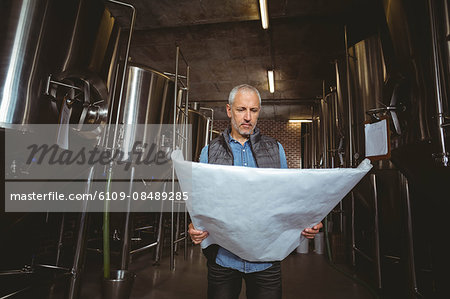 Local brewer standing in the plant at the local brewery