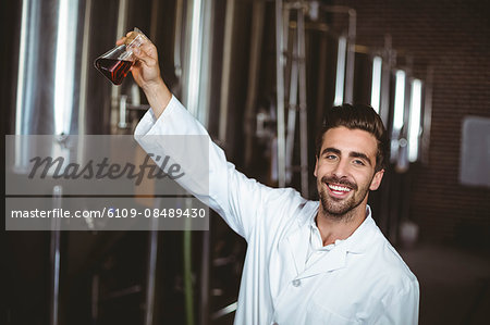 Happy brewer working in the plant at the local brewery