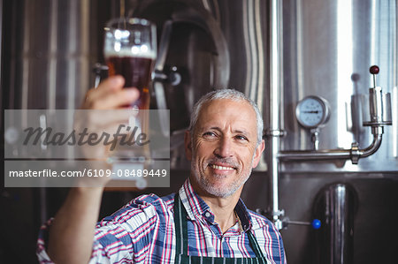 Happy brewer working in the plant at the local brewery