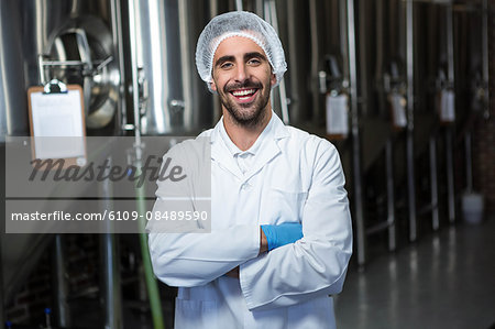 Focused brewer working in the plant at the local brewery