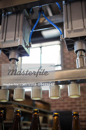 Bottling machine preparing beer bottles at the brewery