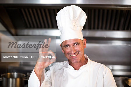 Chef smiling at camera in a commercial kitchen