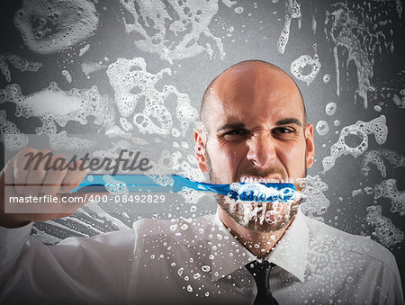Man brushing teeth with a big toothbrush