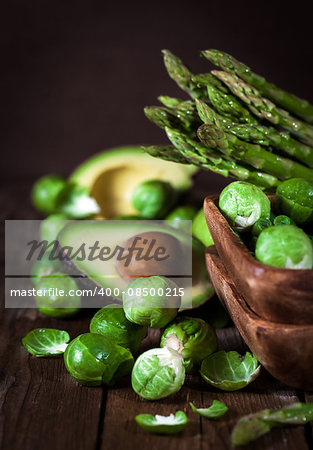 Assortment of fresh green vegetables on wooden table