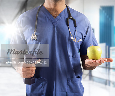 Man doctor with apple and dumbbell weight