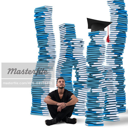 Boy sitting between stacks of study books