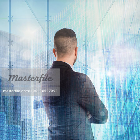 Businessman looks at urban landscape from window