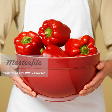 Woman's Hands Holding Bowl of Red Peppers