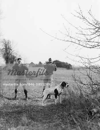 1930s TWO MEN HUNTING SHOOTING SHOTGUNS WITH POINTING DOG