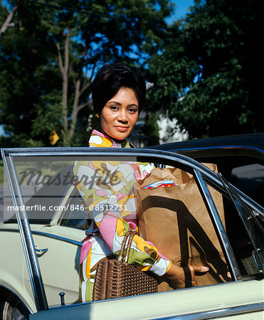 1970s LADY WITH GROCERY BAGS GETTING OUT OF CAR