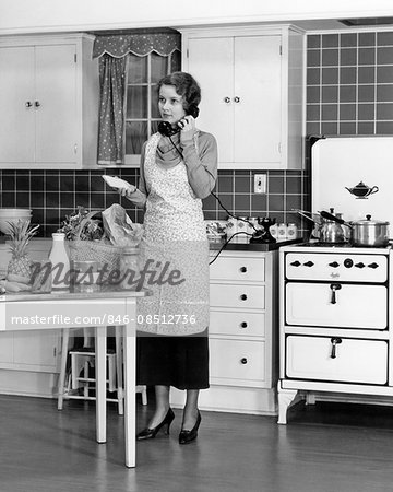 1930s 1920s WOMAN IN KITCHEN GROCERIES ON TABLE TALKING ON TELEPHONE