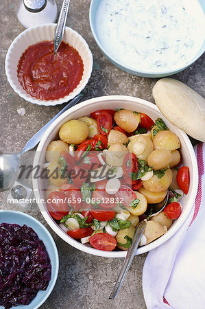 Potato salad with tomatoes, spring onions and basil