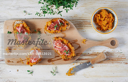 Open sandwiches topped with Parma ham, sweet potato paste and thyme