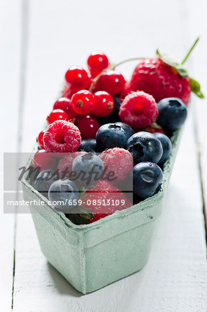 Various berries in a cardboard punnet