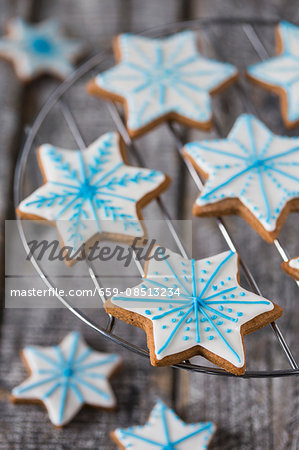 Gingerbread star biscuits decorated with blue and white icing